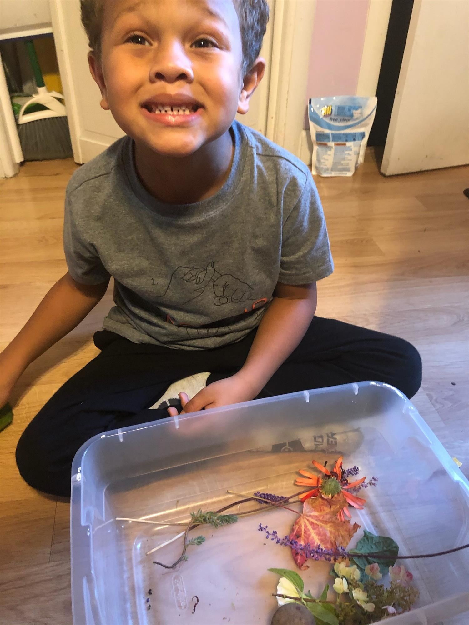 Student Chance Preistly connects quite an assortment of natural supplies for his nature face 